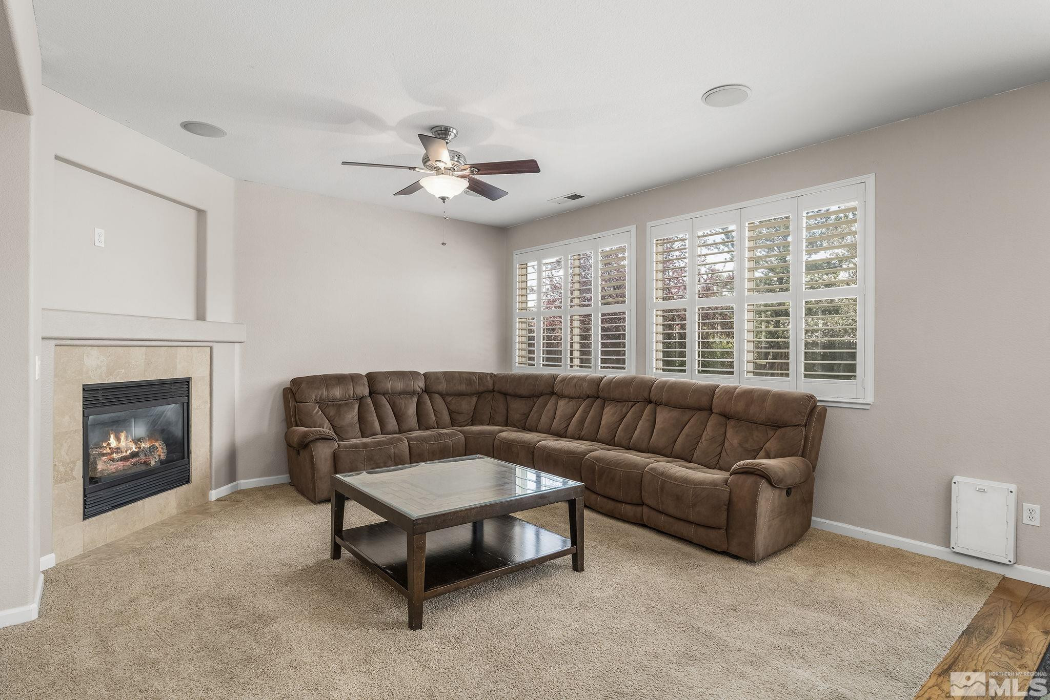 10537 Fort Morgan Way Reno, NV 89521 - Photo 7 of 30 a living room with furniture and a fireplace