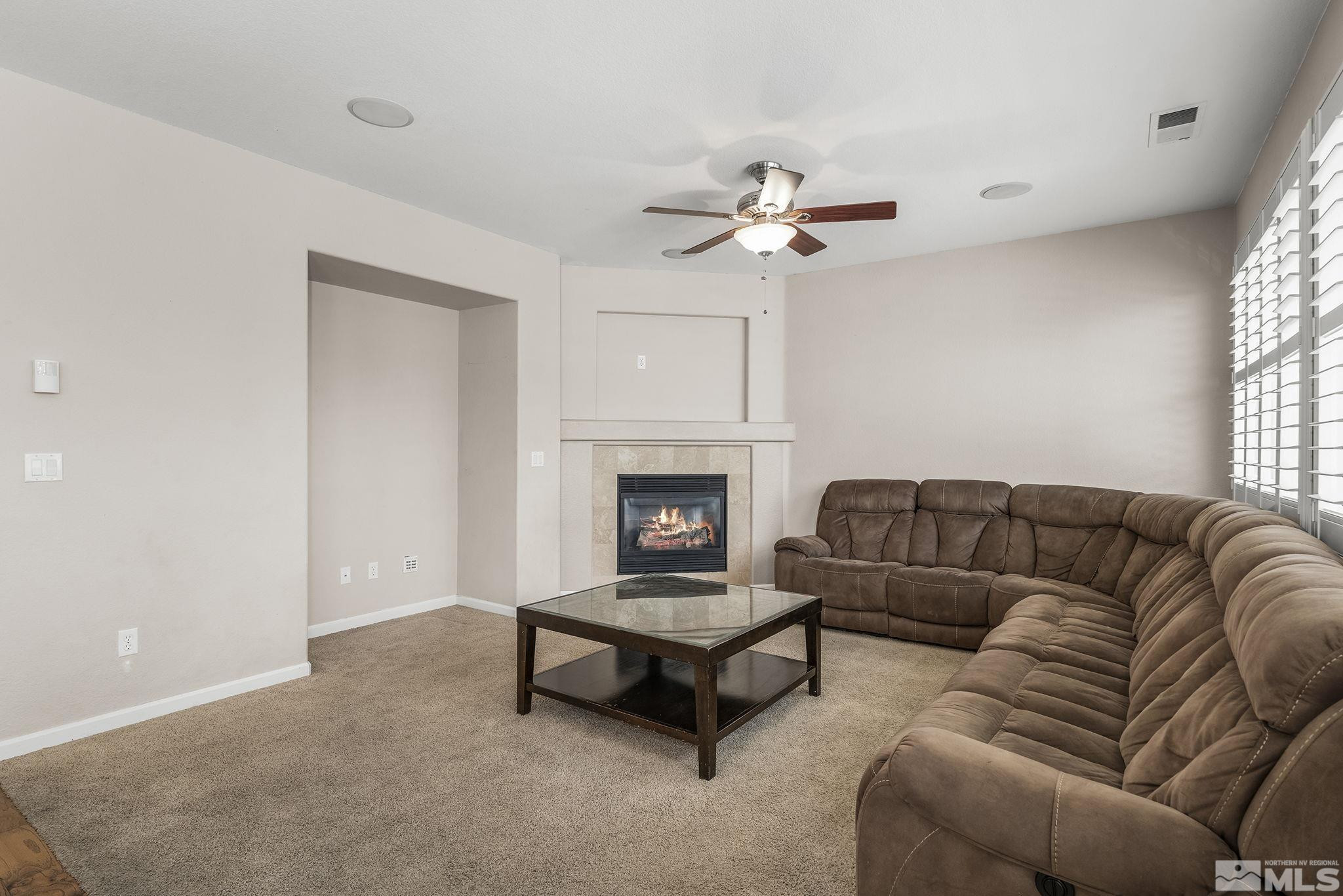 10537 Fort Morgan Way Reno, NV 89521 - Photo 8 of 30 a living room with furniture and a fireplace