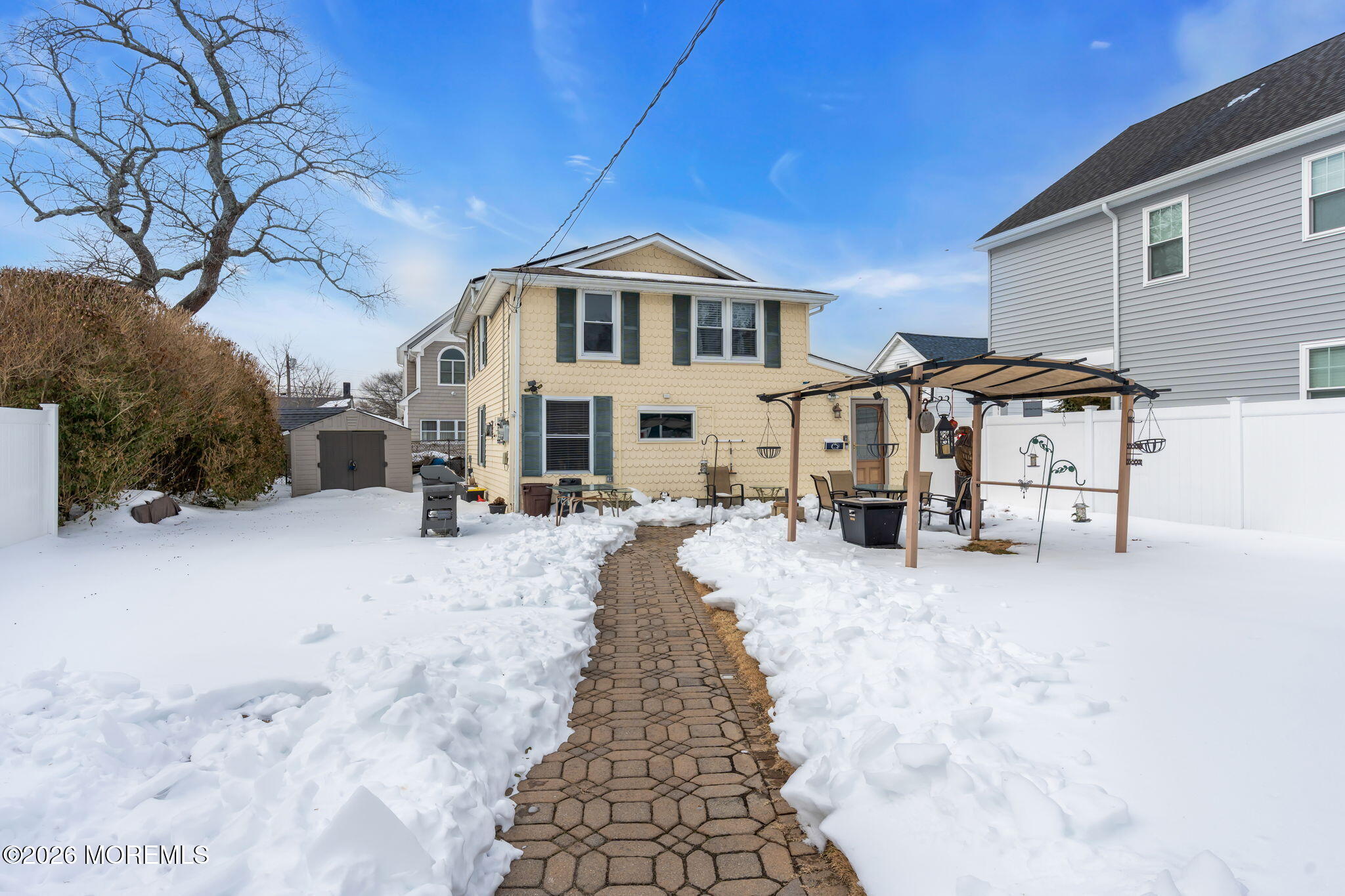 1208 Pine Tree Way, Unit BACK HOUSE Belmar, NJ 07719 - Photo 1 of 24 a view of a house with a yard covered in snow