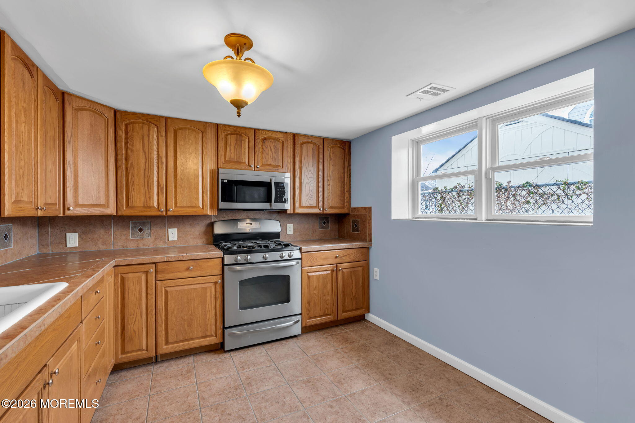 1208 Pine Tree Way, Unit BACK HOUSE Belmar, NJ 07719 - Photo 10 of 24 a kitchen with a stove and a sink