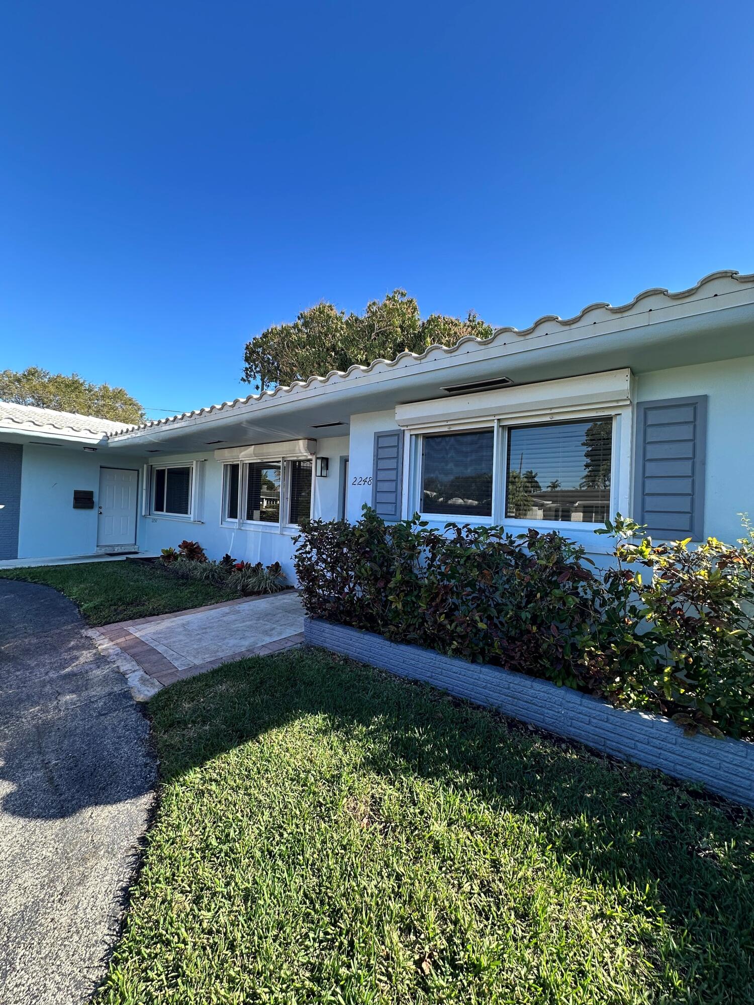2248 Northeast 37th Street Lighthouse Point, FL 33064 - Photo 16 of 19 a front view of a house with a yard