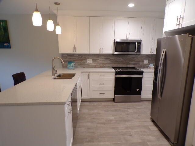 2248 Northeast 37th Street Lighthouse Point, FL 33064 - Photo 3 of 19 a kitchen with a refrigerator sink and cabinets