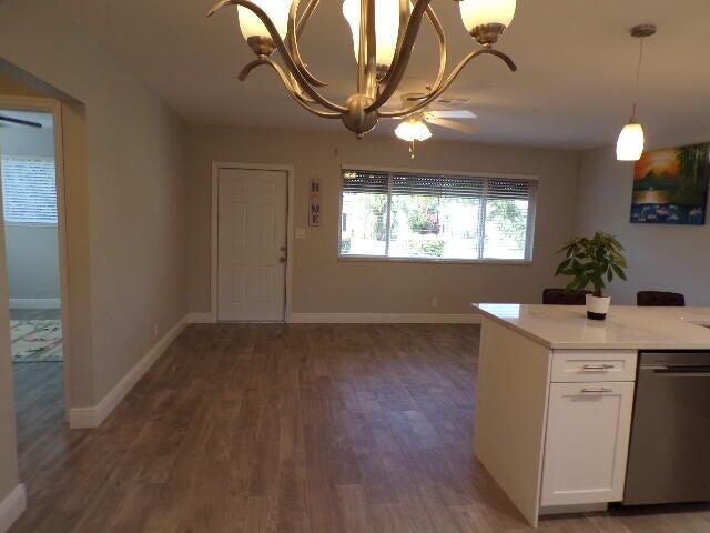 2248 Northeast 37th Street Lighthouse Point, FL 33064 - Photo 5 of 19 a room with a chandelier and wooden floors