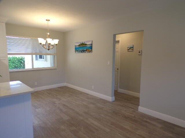 2248 Northeast 37th Street Lighthouse Point, FL 33064 - Photo 6 of 19 an empty room with wooden floor and windows