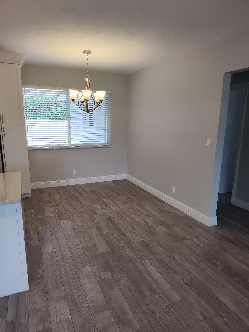 2248 Northeast 37th Street Lighthouse Point, FL 33064 - Photo 8 of 19 wooden floor in an empty room with a window