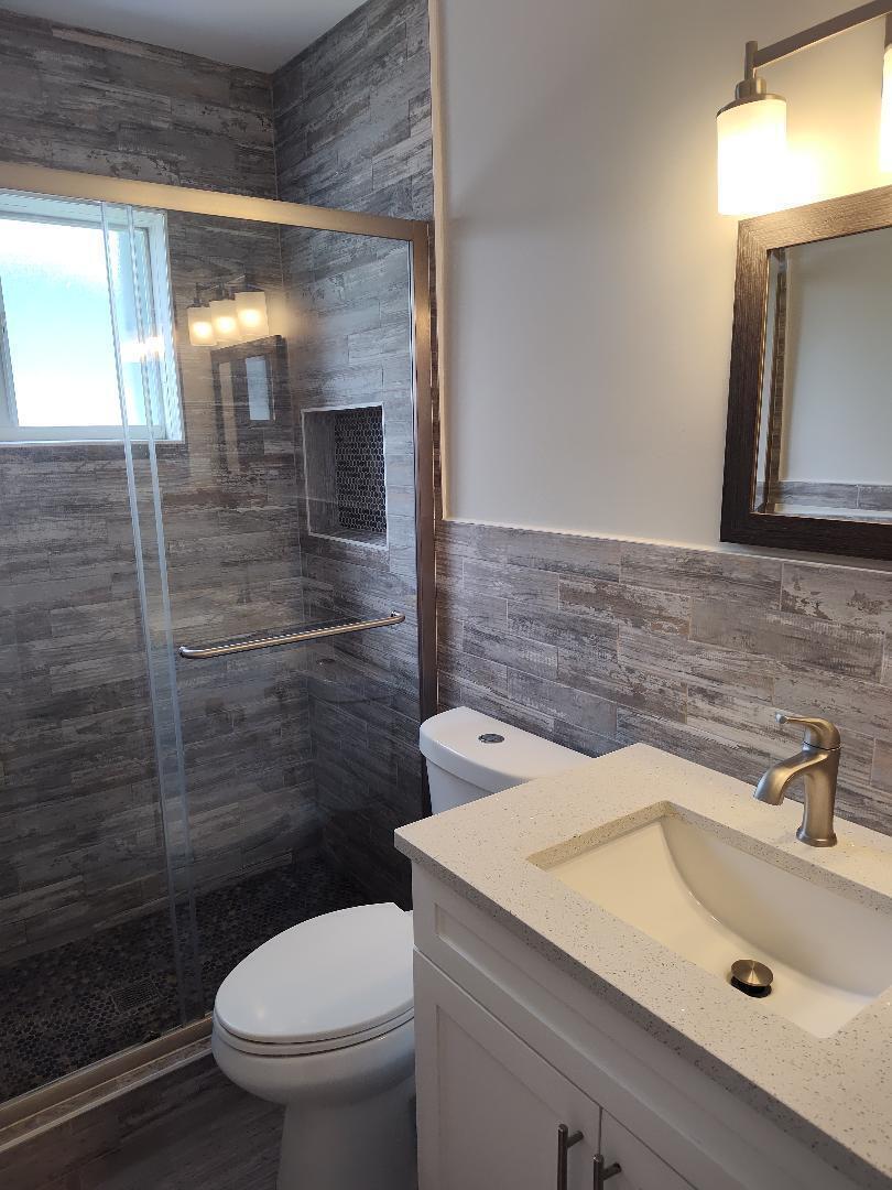2248 Northeast 37th Street Lighthouse Point, FL 33064 - Photo 10 of 19 a bathroom with a sink a toilet and shower