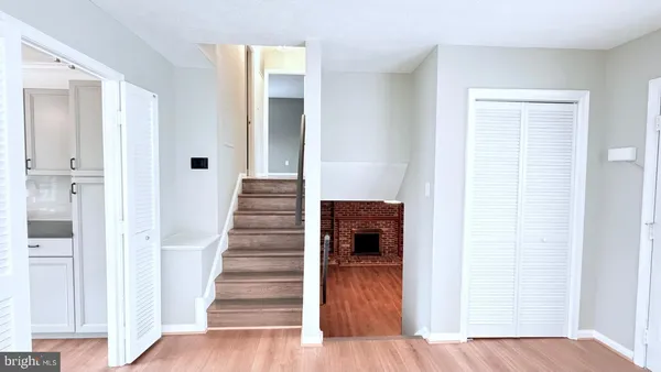 a view of a hallway with wooden floor and entryway