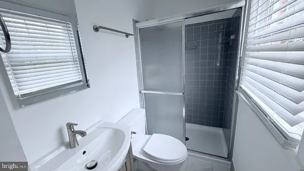 a white toilet sitting next to a bathroom sink