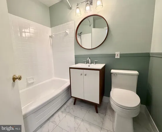 a bathroom with a toilet a sink and a mirror