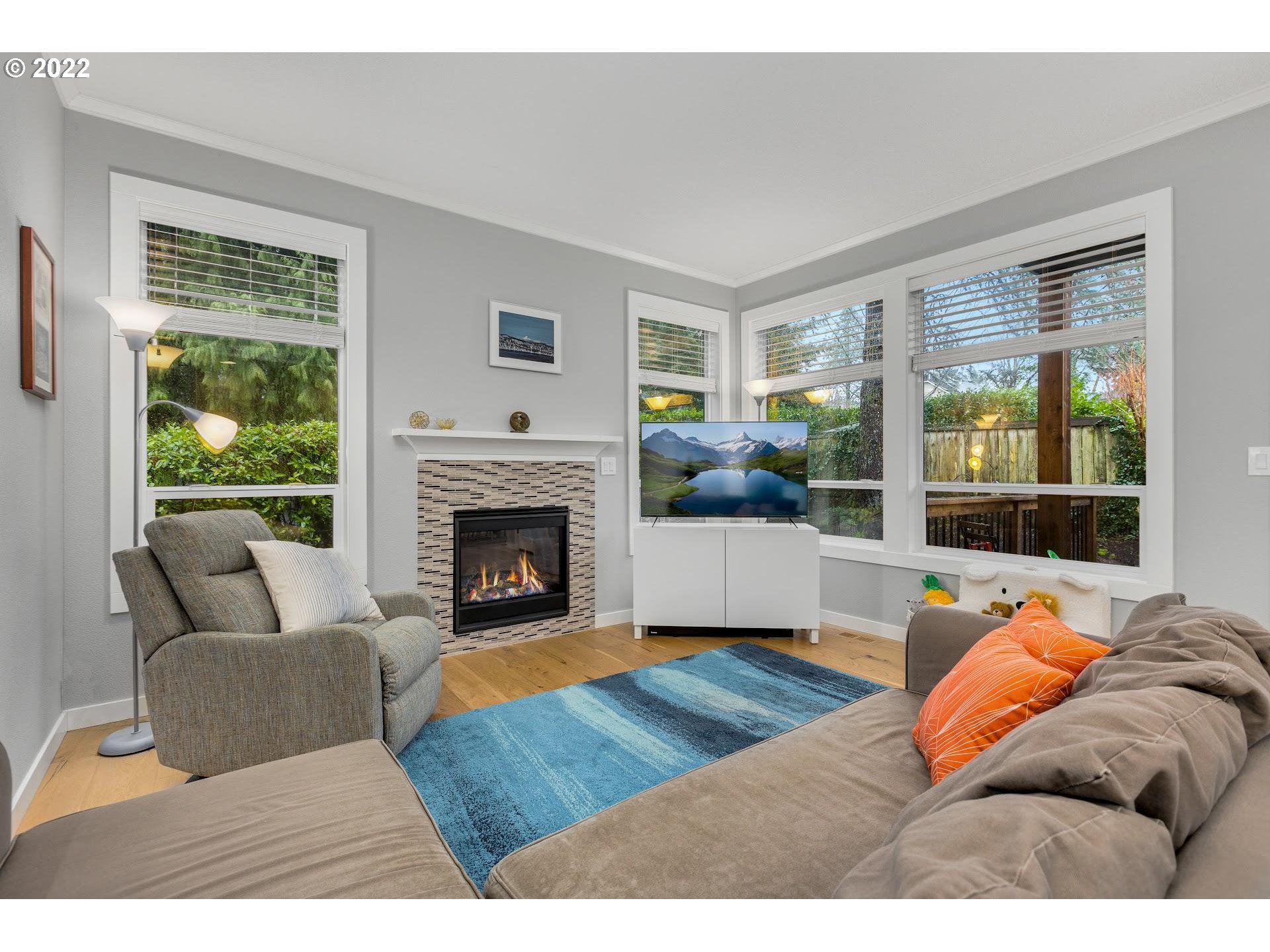 10 Southwest Palatine Hill Road Portland, OR 97219 - Photo 4 of 22 a living room with furniture and a fireplace