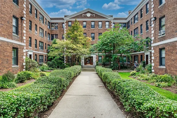 a view of a building next to a yard