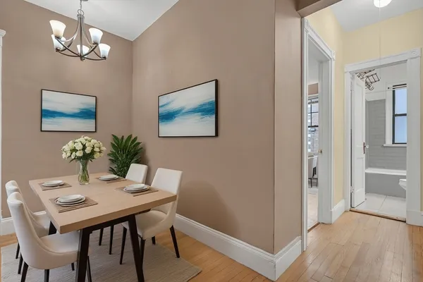 a view of a dining room with furniture and chandelier