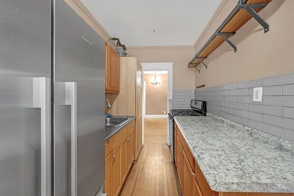 a kitchen with a refrigerator and countertop