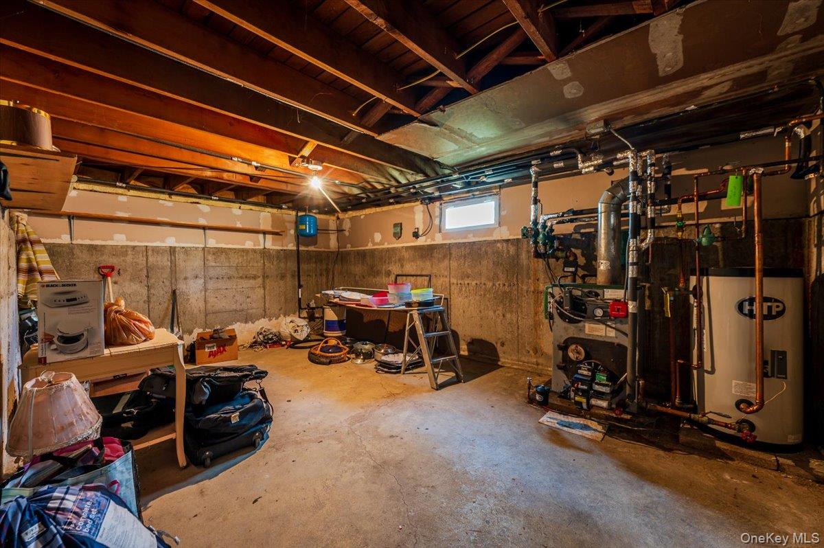 10 Meadow Road Inwood, NY 11096 - Photo 18 of 22 Basement featuring water heater and a heating unit