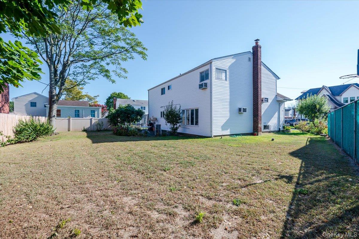 10 Meadow Road Inwood, NY 11096 - Photo 21 of 22 Back of property featuring a chimney