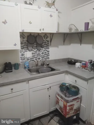 a kitchen with a sink and cabinets