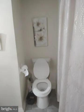 a white toilet sitting next to a small sink