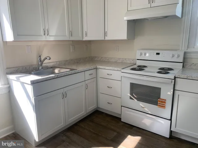 a kitchen with cabinets appliances and sink