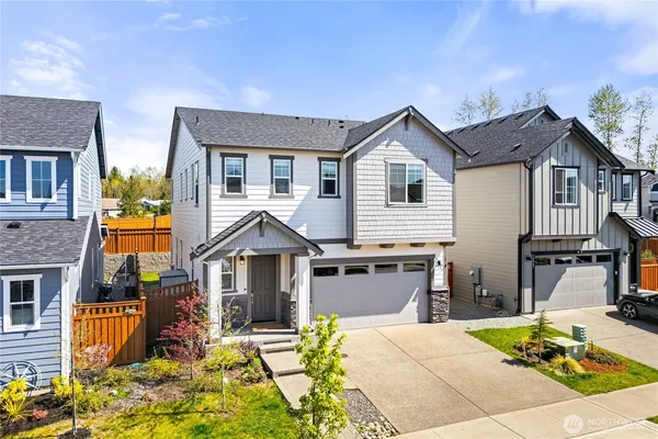 a kitchen with stainless steel appliances granite countertop a table chairs sink refrigerator and microwave