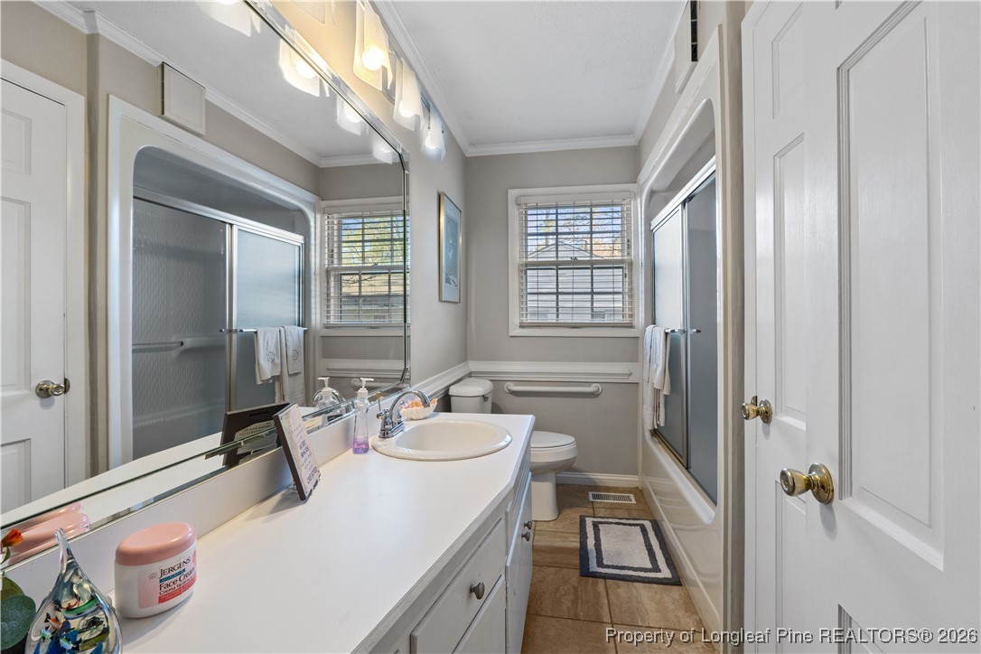 1717 Raeford Road Fayetteville, NC 28305 - Photo 12 of 25 a bathroom with a sink a toilet and a mirror