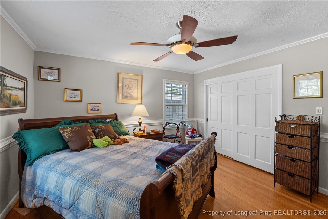 1717 Raeford Road Fayetteville, NC 28305 - Photo 14 of 25 a bedroom with a bed and a chandelier