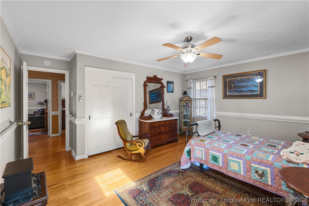 1717 Raeford Road Fayetteville, NC 28305 - Photo 15 of 25 a bedroom with a bed and wooden floor