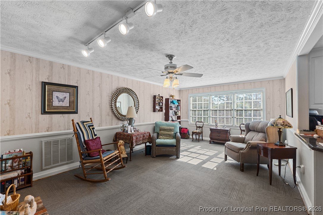 1717 Raeford Road Fayetteville, NC 28305 - Photo 20 of 25 a living room with furniture a fireplace and a large window
