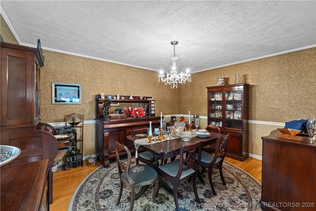 1717 Raeford Road Fayetteville, NC 28305 - Photo 21 of 25 a view of a dining room with furniture and chandelier
