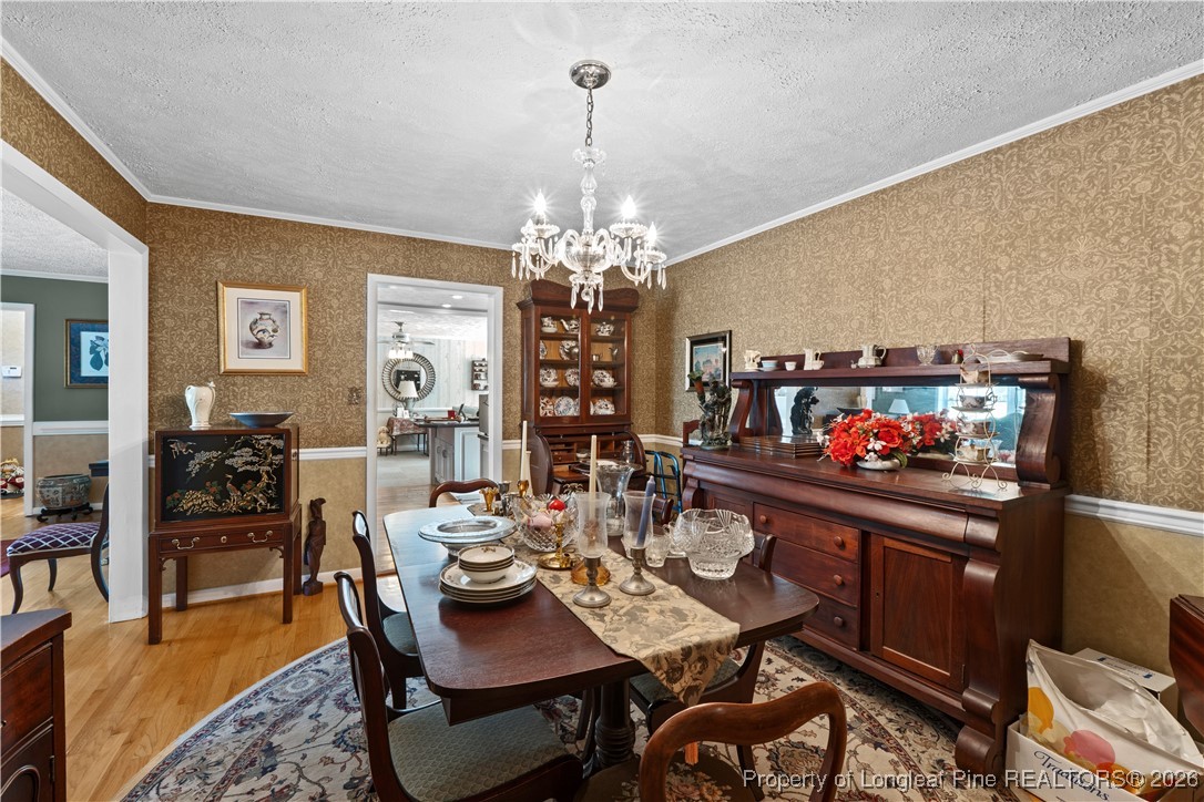 1717 Raeford Road Fayetteville, NC 28305 - Photo 22 of 25 a view of a dining room with furniture and chandelier