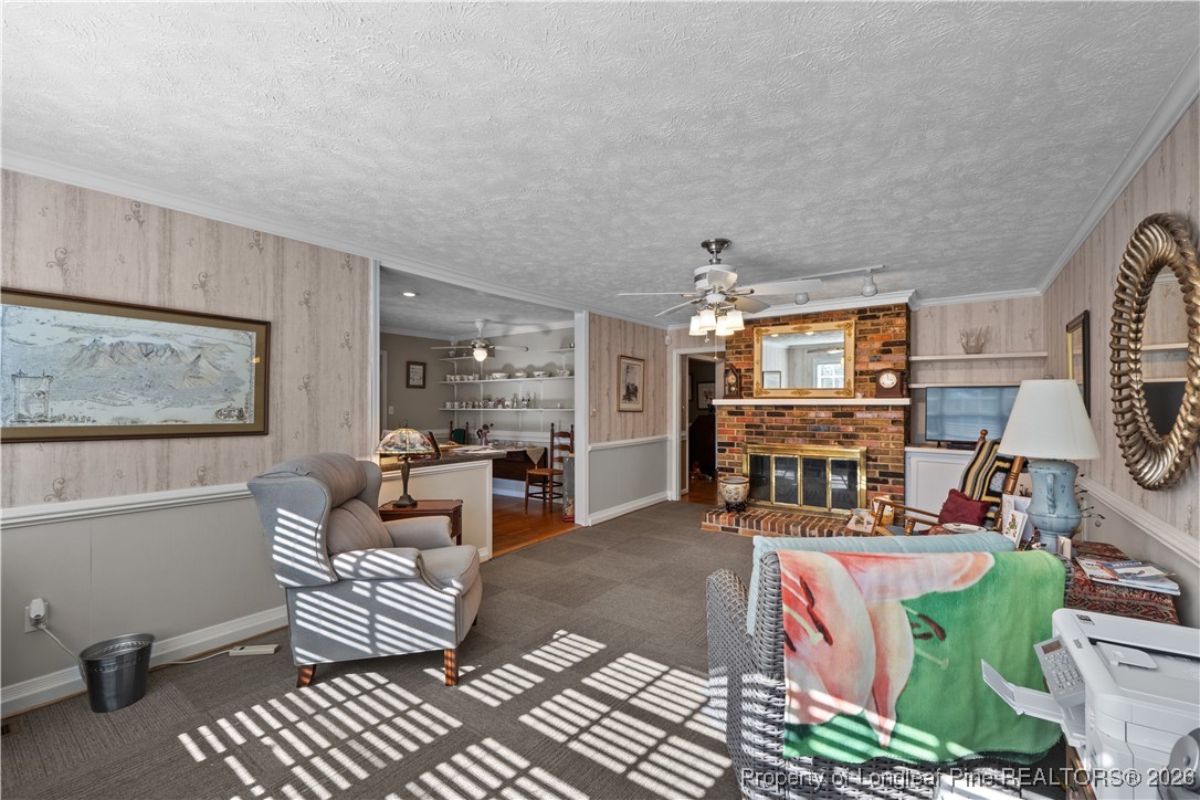 1717 Raeford Road Fayetteville, NC 28305 - Photo 3 of 25 a living room with furniture a fireplace and a flat screen tv