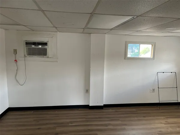 a view of a room with wooden floor and white walls