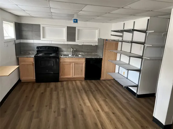 a kitchen with stainless steel appliances granite countertop a stove and a refrigerator