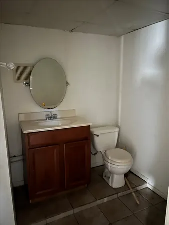 a bathroom with a sink toilet a mirror and vanity