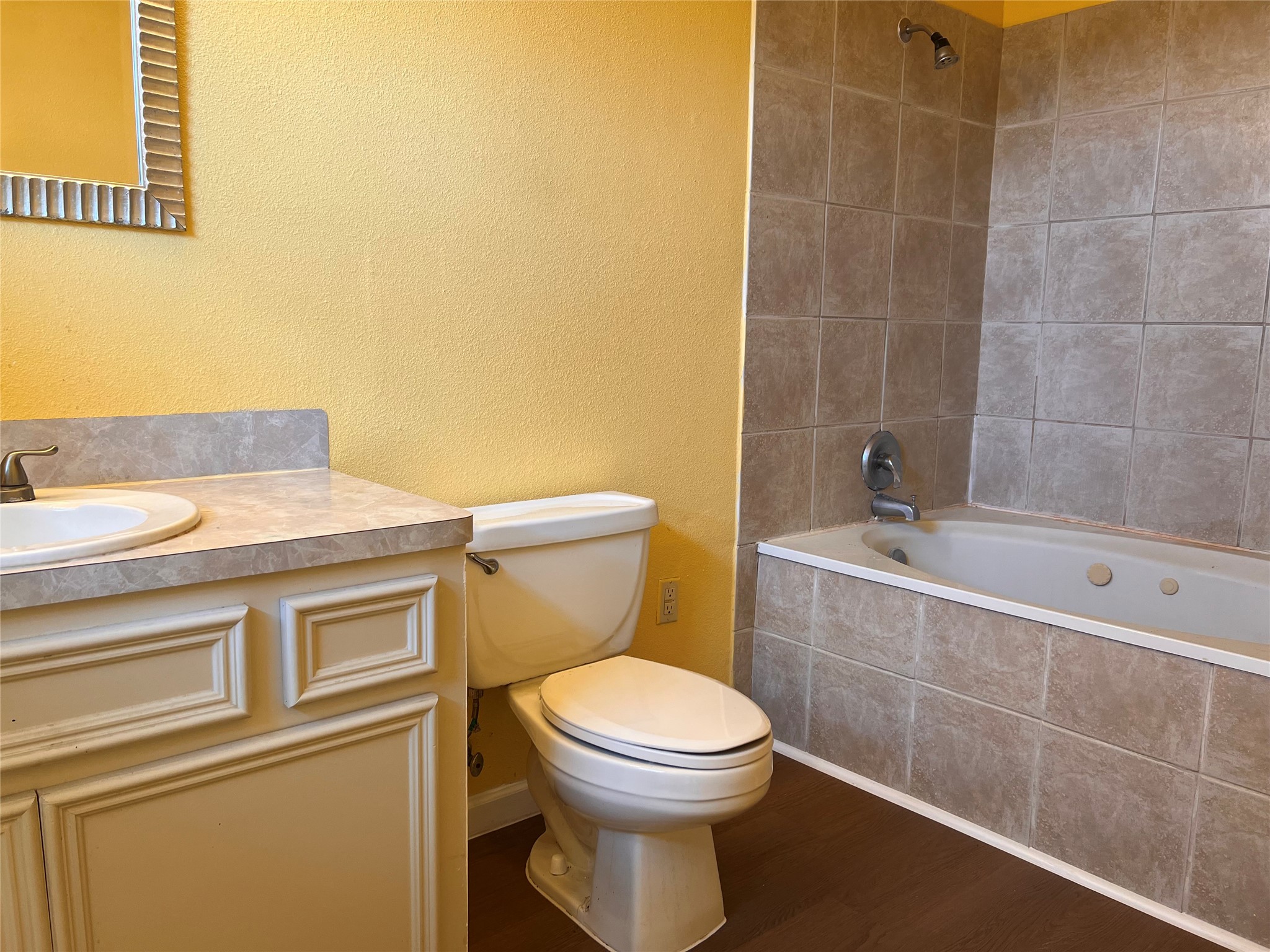 1305 Vista Road Pasadena, TX 77504 - Photo 4 of 29 a bathroom with a toilet a sink and mirror