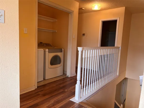 a view of a hallway with washer and dryer
