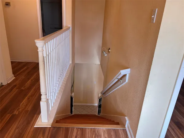 a view of staircase with white walls and a window