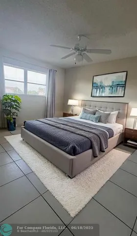 a bedroom with furniture and a large window