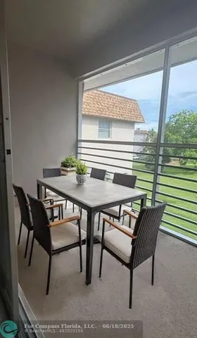 a view of a dining room with furniture wooden floor and a potted plant