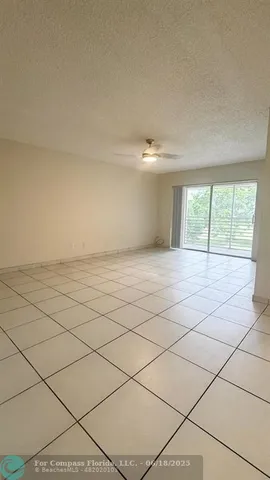 a view of an empty room and a window