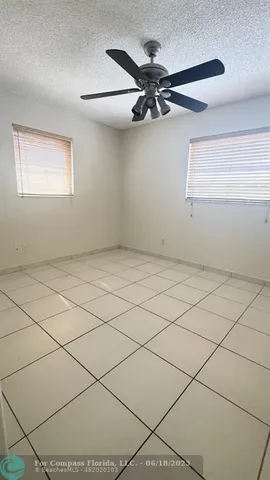 a view of an empty room and a window