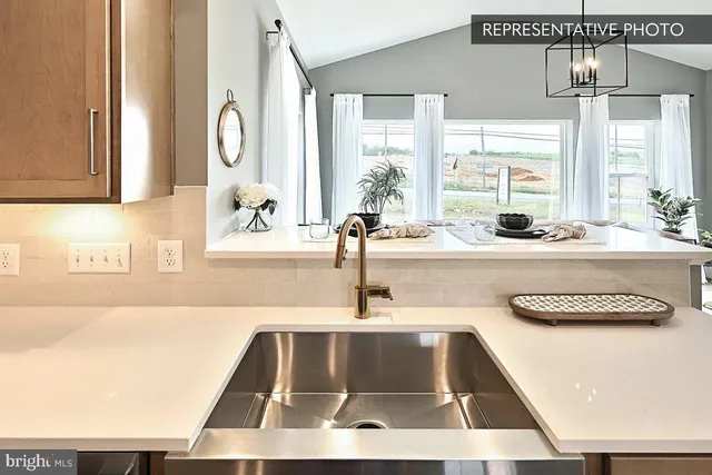 a kitchen with a sink and a stove top oven