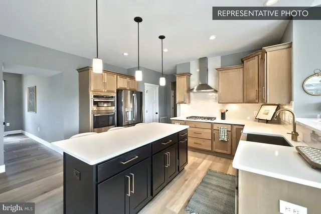 a kitchen with a sink a counter top space a stove and refrigerator