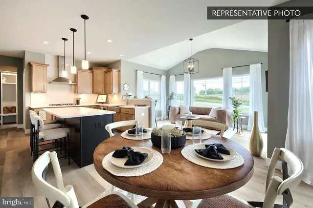 a kitchen with a dining table and chairs