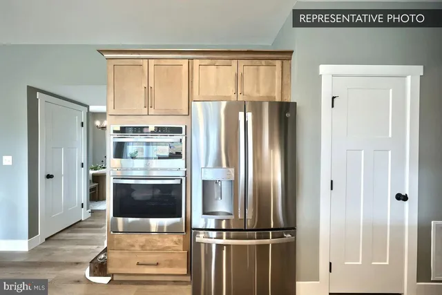 a kitchen with stainless steel appliances granite countertop a refrigerator and a stove