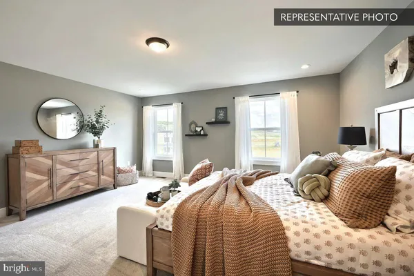 a bedroom with a bed a mirror and a large window