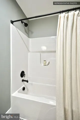 a bathroom with a shower and a tub