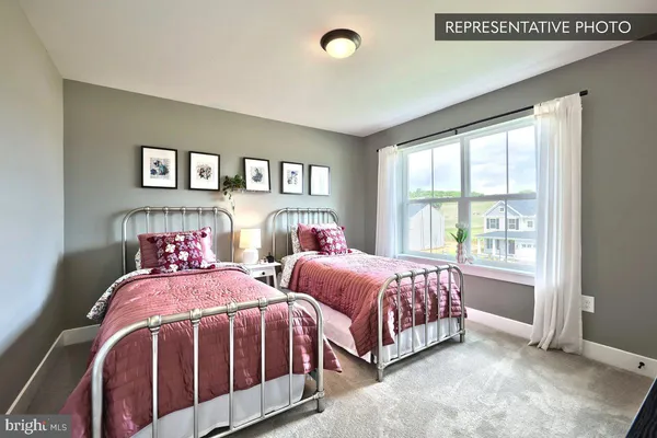 a bedroom with two beds and a window