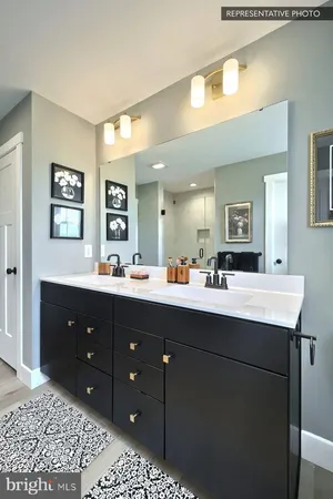 a bathroom with a sink vanity and mirror