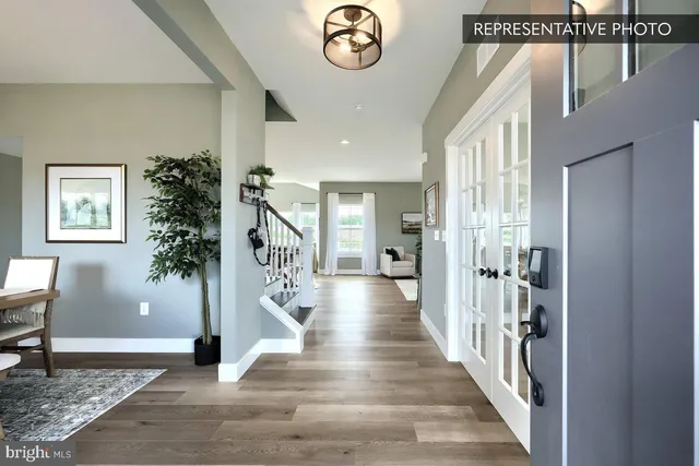 a view of entryway and hall with wooden floor