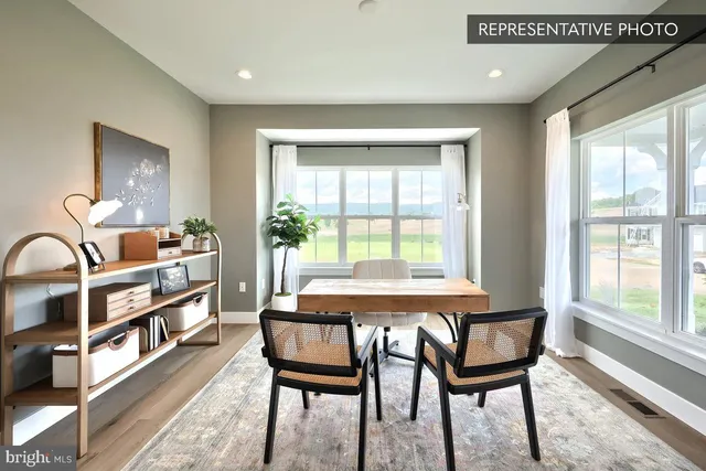 a dining room with furniture and a window